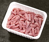 Strips of pork in plastic container