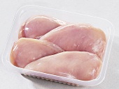 Fresh chicken breast fillets in plastic container