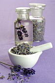 Lavender flowers in mortar and apothecary bottles