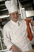 Chef with lobster in a commercial kitchen
