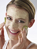 Woman with cucumber face mask