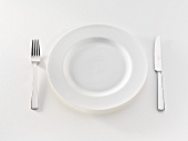 White plate with knife and fork