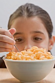 Little girl eating macaroni cheese