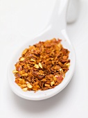 Chilli flakes on spoon (close-up)