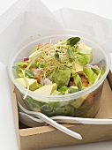 Avocado salad with sprouts in plastic container to take away