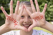 Girl showing her hands with the words THINK PINK