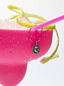 Frozen Margarita with lime zest in pink glass