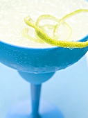 Frozen Margarita with lime zest in blue glass