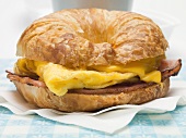 Croissant with scrambled egg, cheese & bacon (close-up)