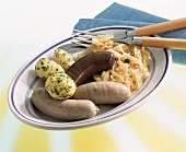 Black pudding and liver sausage with sauerkraut and parsley potatoes
