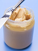 Peanut butter in jar with knife