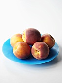 Peaches on a blue plate