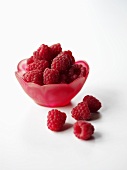 Raspberries in a red dish