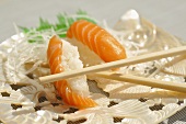 Salmon nigiri with chopsticks