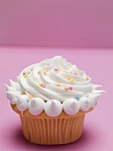 Cupcake with cream and sugar confetti