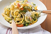 Tagliatelle primavera with vegetables & grated cheese on plate