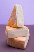 Three pieces of washed-rind cheese
