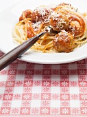 Spaghetti with tomato sauce, meatballs and a fork