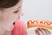 Girl eating a hot dog