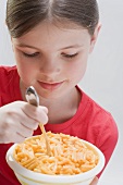 Little girl eating pasta