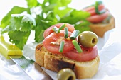 Bruschetta with tomatoes, olives and chives