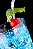 Oasis cocktail (gin, Blue Curacao, tonic water, crushed ice) with a cocktail cherry and mint