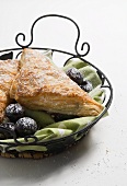 Turnovers with Powdered Sugar and Figs in Metal Basket