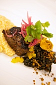 Maple Soaked Angus Beef Tenderloin on Jalapeno Grits and Greens