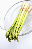 Green Thai asparagus in strainer insert