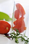 Partly sliced tomato in glass