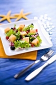 Mixed salad leaves with melon and berries