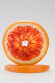 Slice of blood orange, standing on its edge
