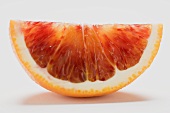 A wedge of blood orange