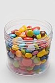 Coloured chocolate beans in jar
