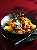 Szeged turkey goulash on potatoes