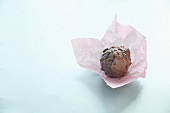 A chocolate truffle on paper