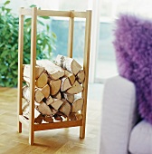 Firewood in a rack beside a couch