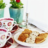 Plate of assorted biscuits, cups and saucers