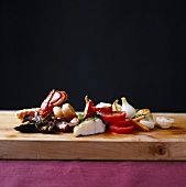 Seafood and vegetables on wooden board
