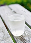 A glass of water on a table out of doors