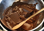 Melting chocolate couverture over bain-marie