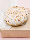 Iced doughnut with chopped nuts