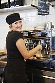 Café employee at espresso machine