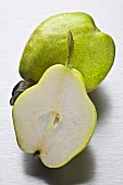Whole green pear and half a pear