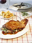Leg of lamb with olive and caper sauce