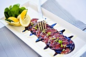 Beef carpaccio with Parmesan basket, balsamic reduction