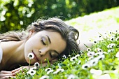 Young woman lying on grass
