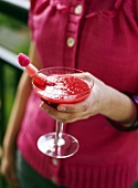 Woman holding a fruity cocktail