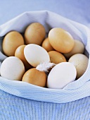 White and brown eggs in striped cloth