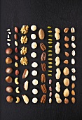 Verschiedene Nüsse und Kerne in Reihen